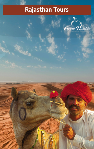 Rajasthani man in traditional attire resting with his decorated camel in the Thar Desert during a Rajasthan tour with Apple Ramble.